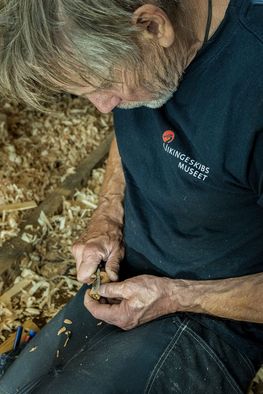Boatbuilder Hanus Jensen carves a cork plug to fit into a knot hole. Photo: Werner Karrasch / The Viking Ship Museum in Roskilde, Denmark Boatbuilder Hanus Jensen carves a cork plug to fit into a knot hole. Photo: Werner Karrasch / The Viking Ship Museum in Roskilde, Denmark